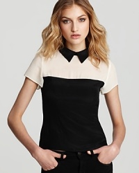 Monochrome color blocking lends statement style to this Nanette Lepore top in luxe silk. A contrast collar lends a whimsical finish.