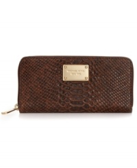 MICHAEL Michael Kors brings a touch of the exotic to the everyday with this python-embossed leather wallet, featuring signature-embossed hardware and slim, sophisticated shape. Slip it in your handbag or wear it on its own, for a wildly alluring way to stay organized.