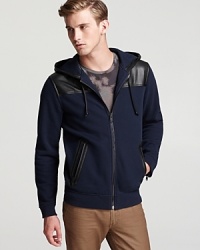 Leather accents elevate this sweatshirt from laid-back to luxury, a perfect complement to your casual cool wardrobe.