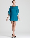 Dolman flutter sleeves lend a caftan-like look to a chiffon Trina Turk dress, dressed up with a beaded neckline.