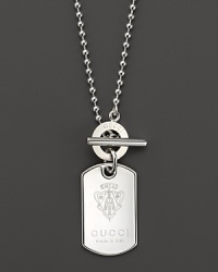 The Gucci crest adds a touch of fashion royalty to this sterling silver dogtag necklace, finished with a toggle clasp.