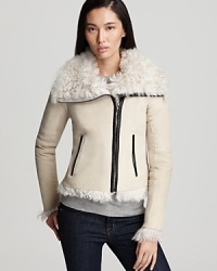 Experience the exceptional warmth of this luxurious shearling Theory jacket that flaunts a lofty curly collar and trim.