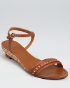 A multicolored wedge peeks out from the sole of these Jack Rogers sandals, a simple style with all the right details.