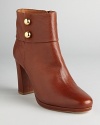 These commanding booties spell sophistication; metallic, military inspired buttons add some dash; from kate spade new york.