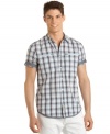 Modern hit. Taking traditional plaid seersucker and adding a contemporary accent, this shirt from Calvin Klein finishes your contemporary cool.