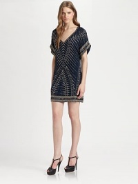 Constructed with luminous beads that form a tribal pattern, this silk v-neck dress has dropped shoulders, short dolman sleeves and a short silhouette. V-neckDropped shouldersShort dolman sleevesAbout 18 from natural waistBeaded silkDry cleanImportedModel shown is 5'10 (177cm) wearing US size Small.