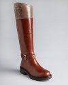 Perfed perfection: Tory Burch lightens up riding boots with perforated logo details and pale shades of leather. Sturdy lugged soles will take you places.