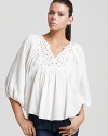 Embroidered cutouts and mirrored accents lend a rich artisan feel to this floaty Rebecca Taylor blouse.