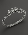 John Hardy's Naga bracelet lends fierce style with a dragon design crafted in sterling silver, accented with diamonds.