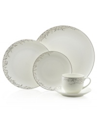 Sleek coupe dinnerware fringed with shimmering leaves of platinum and mica turns your table into a springtime utopia. Clean lines and whites create a vision of modern elegance in banded bone china place settings.