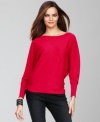 The slouchy-chic fit of INC's dolman-sleeve sweater makes a cool counterpoint to the sparkling, metallic-flecked fabric.