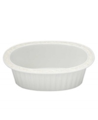 This pristine white serveware features gently scalloped rims and raised patterns of cascading vines. Perfect for casual dining or formal entertaining, this charming oval baker is sure to enhance mealtime at your home. Can go from freezer to oven! From Lenox's dinnerware and dishes collection.