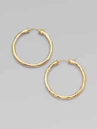 From the Martellato Collection. Graceful hoops with a rich hammered texture in gleaming 18k gold.18k yellow goldDiameter, about 1¾PiercedMade in Italy