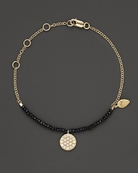 A diamond circle charm and black spinel gems great dramatic beauty on a 14K. yellow gold chain. By Meira T.