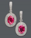 Captivate the room with these dazzling drop earrings. Oval-cut ruby (2-1/5 ct. t.w.) takes center stage among glittering round-cut diamond (1/6 ct. t.w.) set in 14k white gold. Approximate drop: 3/4 inch.