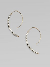 Delicate arcs of 14k gold are set with faceted beads of sterling silver and gold in these elongated, modern hoops with a subtle shimmer.14k yellow gold and sterling silverLength, about 1¼Ear wireMade in USA