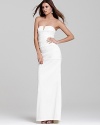 Though understated, this Nicole Miller strapless gown undoubtedly makes a statement. Subtle ruching down the length of the silhouette creates a figure-flattering shape.