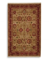 Inspired by an early 20th-century carpet woven in western Turkey, this oushak rug features an enlarged palmette trellis design surrounded by a rosette border in a rich palette of red, gold and green. Subtle gradations of color evoke the timeworn striated effect created by aged vegetable dyes. A patented wash process further harmonizes the colors into a rich vintage finish. Woven in the USA in premium worsted New Zealand wool for luxurious softness.