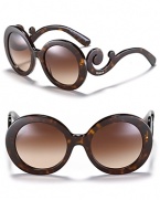 Thick round frames and curling temples make for statement-making sunglasses from Prada.