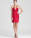 A hit of hardware lends a trend-right look to BCBGMAXAZRIA's standout halter dress--a plunging neckline flaunts the figure.