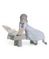 Feathered friends. Three little birds eat right out of the hands of a gentle young lady dressed in a pretty blue dress and shoes. A classic Lladro collectible in handcrafted porcelain.