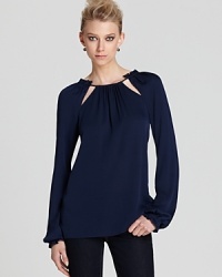 A drawstring neckline with chic cutout details lends architectural elegance to this Rachel Zoe top.