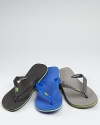 Classic kick-around beach sandals rendered in rugged rubber and accented with the Brazilian flag at the strap upper.