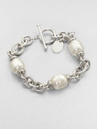 Three beautiful pearl stations on a rhodium-plated stainless steel chain link design. 12mm organic white baroque man-made pearlRhodium-plated stainless steelLength, about 7.5Toggle closureImported