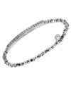 Stackable styles a must! Michael Kors' chic stretch bracelet pairs perfectly with bangles or bracelets. Beads and bar accent are crafted in silver tone mixed metal and accented by pave-set glass accents. Approximate diameter: 2-1/4 inches. Approximate width: 1/8 inch.