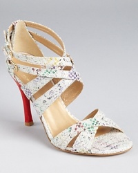 A bold red heel accents rainbow-flecked snakeskin. From Stuart Weitzman.