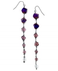 Purple beads lead the way to modern style. These drop earrings from GUESS features amethyst glass beads on a linear silhouette. Crafted in hematite tone mixed metal. Approximate drop: 4 inches.