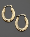 Stretch your style with these versatile elongated etched 14k gold hoop earrings. Approximate diameter: 1/2 inch. Approximate length: 1 inch.