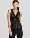 Fanciful lace defines an artfully gathered Karen Kane tank for a delicate yet daring style statement. Finish with a sharp blazer for a strong, feminine look.