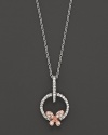 A dainty diamond butterfly pendant set in 14K. rose and white gold.