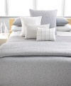 Calvin Klein's Mykonos Pewter sham features a textured circle pattern dispersed across a jacquard woven satin ground for a sleek, contemporary look. Hidden button closure.