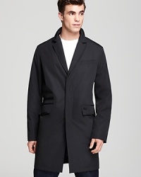 A modish mid-length coat that translates from work to after hours from Tumi.