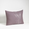 A pillow with muted colors and decorative leaf pattern. Coordinates with Port Stripe sheets in Plum and Jagged Grid coverlet in Azuki.