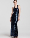 Brilliant sequins lend a glamorous look to a sleek BCBGMAXAZRIA maxi dress--a racerback boasts a sporty silhouette.