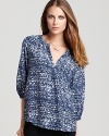 Laid back in pure silk, this inviting Joie top features stylish three-quarter sleeves and a serene bi-color print.