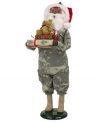 Singing their praises, Santa Claus honors military families in a camouflage suit and iconic red hat. In his arms are extra-special gifts piled high and topped with an adorable stuffed bear. An all-American figurine, handcrafted by Byers' Choice.