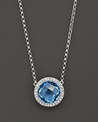 Blend some cool blues into your look. This stunning blue topaz pendant necklace features gleaming diamond accents on 14 Kt. white gold.