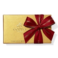 A classic assortment of Belgian chocolates from Godiva comes in a beautiful gold box tied with big red bow and holiday pick. Each ballotin includes Godiva signature favorite ganaches, pralines, caramels, fruits and nuts in milk, dark and white chocolate.