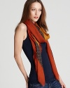 A large woven square scarf with a geometric print and contrast border, an edgy accent for your favorite ensemble.