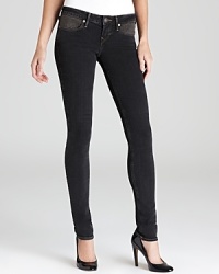 Striking studded front pockets set these black washed True Religion skinny jeans apart from all the rest.