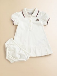 Soft, airy pique knit with sporty stripes, perfect for your future tennis star.Ribbed polo collar with two-color striped tippingShort sleeves with ribbed, tipped cuffsButton placketLogo appliqué at chestBox pleated hemMatching bloomers with elasticized waist and leg openings96% cotton/4% elastaneMachine washImported Please note: Number of buttons may vary depending on size ordered. 