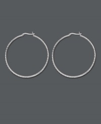 Chic, versatile style with a designer edge. Traditional hoop earrings feature an intricate diamond-cut pattern. Crafted in sterling silver. Approximate diameter: 2 inches.