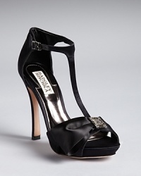 Stand tall and stately in Badgley Mischka T-strap sandals with refined jeweled bow accents.