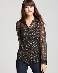 Metallic details lend subtle sparkle to this sheer GUESS top--layer on a cami, dress up your denim and make your mark.