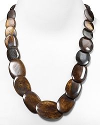 The 60's-inspired look of this wood-effect disc necklace from Kenneth Jay Lane makes it a Mod-chic way to punctuate every outfit. It's vintage perfect with this season's punchiest prints and a pair of platforms.