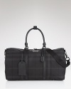 Travel in style with Burberry--this check printed holdall is polished and practical.